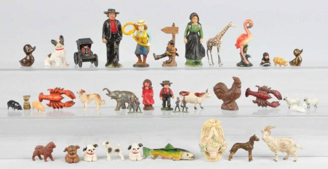 Large Lot of Cast Iron Figural Pieces.: Includes one Amish couple, one cow girl with lasso bottle opener, one inebriated man holding lamppost, two small Amish children, one flamingo, several animals, large assortment of dogs, several Hubley