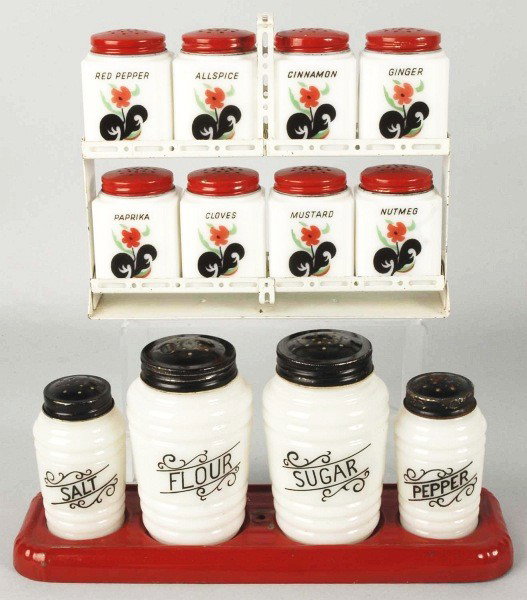 Lot of Range, Spice, & Salt and Pepper Sets.: 1930s to 1940s. Includes Tipp Novelty Co. black leaf flower set of eight spices with rack and all original tops. Also includes Hazel Atlas round ribbed Platonite range set of four including salt, pepp