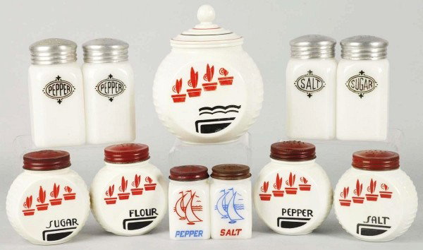 Lot of Range, Spice, & Salt and Pepper Sets.: 1930s to 1940s. Includes Anchor Hocking Corp. Vitrock set of five Deco red flower pots. Set consists of salt, pepper, sugar, flour, and a grease jar. Hazel Atlas Co. square shield in black. Various sh