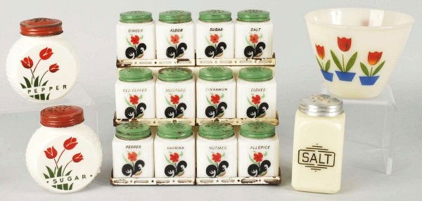 Lot of Range, Spice, & Salt and Pepper Sets.: 1930s to 1940s. Includes Tipp Novelty Co. black leaf flower spice set of 12 with rough original stand and green tops. Anchor Hocking red tulips pepper and sugar shakers with original tops. Mckee Glass
