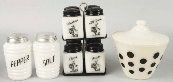 Lot of Range, Spice, & Salt and Pepper Sets.: 1930s to 1940s. Includes Tipp Novelty Co. set of eight with original tops and revolving stand. Hazel Atlas black letters salt and pepper set with replaced tops. Also includes Anchor Hocking black dots