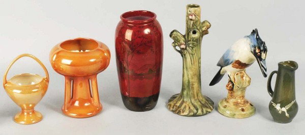 Lot of 6: Assorted Pottery Pieces.: Includes six pieces signed "Weller" consisting of one tree form and decorated stick vase, one orange lustre chalice form vase, one orange lustre basket handled vase, one handled piece decorated with f