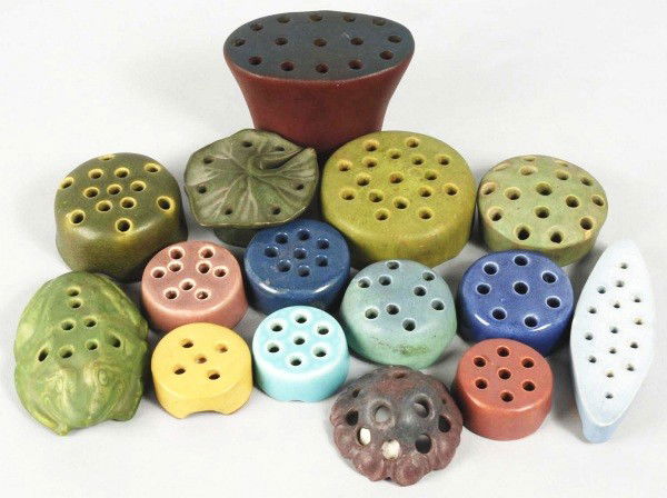 Lot of 15: Assorted Flower Frogs.: Includes four marked "Rookwood Pottery", one high glaze blue Weller, one speckled glazed Peters & Reed, one tall mulberry and dark blue Van Briggle with one glaze chip to one of the sculpted feet, one