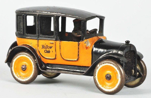 Cast Iron Arcade No. 2 Yellow Cab Toy.: American. Rear molded spare tires. Mesh grille. Original driver. Rubber stamped "Yellow Cab" on side doors. Some paint chipping and wear to roof and wheels. Size:7 - 3/4" L.