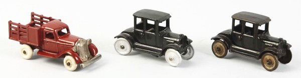 Lot of 3: Cast Iron Vehicle Toys.: American. Includes two Hubley Ford Model T coupes and one Arcade Plymouth stake truck. Some chipping and wear to roof of one of the Model Ts. Size:Largest: 4 - 1/2" L.