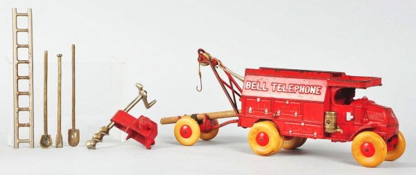 Cast Iron Hubley Bell Telephone Truck Toy.: American. Scarce red color variation. Original barrel and molded driver. Comes with tools, one auger, and one pole carrier with replacement wheels. Some paint loss and wear throughout. Replaced rubber