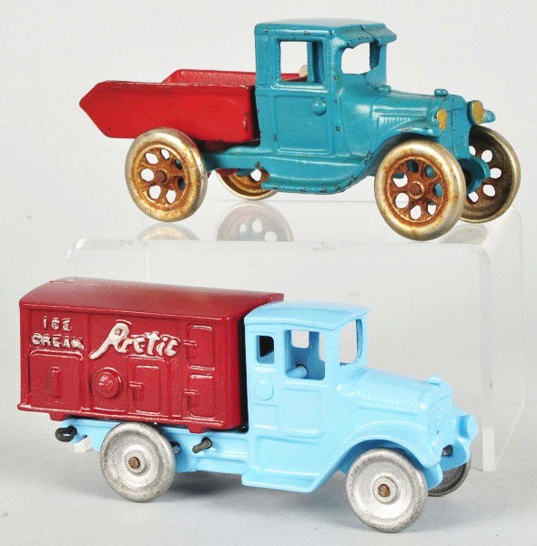 Lot of 2: Cast Iron Truck Toys.: American. Includes one repainted Kilgore Arctic Ice Cream truck embossed "Ice Cream" on both sides and marked "Kilgore" on bottom. Also includes one Arcade Ford Model A dump truck with new Arcade Toy