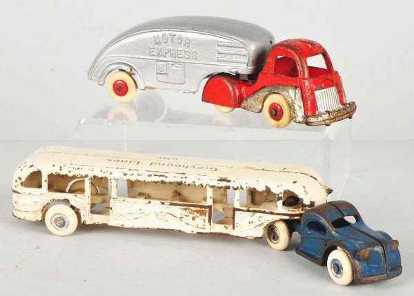Lot of 2: Cast Iron Vehicle Toys.: American. Includes one Arcade Greyhound Lines GMC tractor trailer bus and one Hubley Motor Express tractor trailer truck with rear piece that has been repainted. Size:Largest: 10 - 1/4" L.