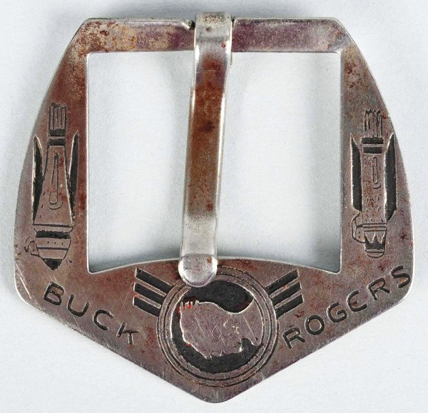 Vintage Buck Rogers Silver Belt Buckle.: 1937. Made by the Reliable Belt Company. Marked "Buck Rogers" on front with strong pictures of two rocket ships. Originally attached to a leather belt. Very little wear, mostly to back. Size:1 - 7/8" 