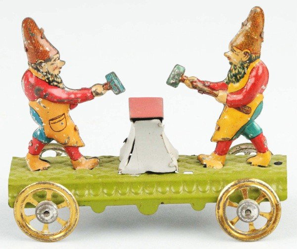 Tin Litho Gnomes Hammering Anvil Penny Toy.: German. On platform with gold-wash wheels. Depicts two gnomes holding hammers and simulating hitting a blacksmith's anvil. Some litho loss to figures. Size:3 - 1/2" L.