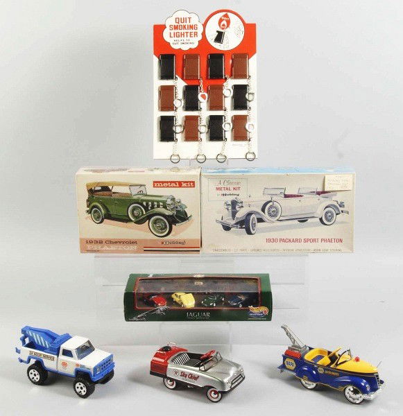 Miscellaneous Lot of Vintage & Contemporary Items: Includes two sealed Hubley metal car kits in their original boxes, one Hot Wheels car set, three contemporary trucks, two plastic dolls, one lighter display, and one dairy thermometer with original bo