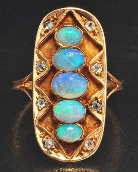 14K Y. Gold Diamond & Opal Ring.: Diamonds: 0.09 ctw. Opal: 0.89 ct. Size: ADDITION – Size 5-1/2. 1-1/8”L, 1/2”W. One opal with dent on rim. Opal has nice blue green color.