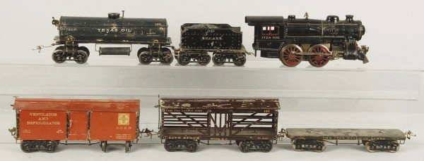 Ives Standard Gauge Freight Train Set.: Description American. Pre-war. This rare set includes scarce no. 1132 cast iron locomotive and tender, no. 196 olive green flat car, no. 192 brown refrigerator car with Santa Fe markings, no. 190 gray