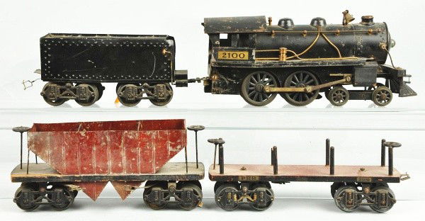 Lot of Boucher & Voltamp Train Items.: Description American. Includes Boucher 2100 steam engine and tender, Voltamp brown hopper car, and Voltamp 2109 PRR gondola car. Locomotive has loose cab roof and some paint flaking and wear. Tender i