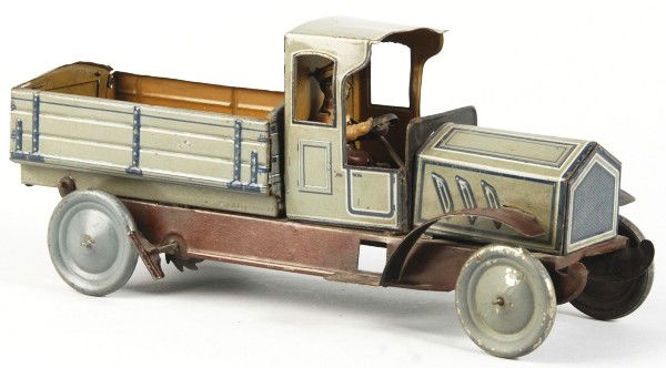 Tin Litho Dump Truck Wind-Up Toy.: Description German. Working. Includes original lithographed driver and opening latch-operated back door in truck bed with the Hans Eberl clown mark. Some scratching and wear overall. Condition (Very G