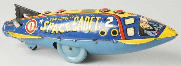 Tin Marx Tom Corbett Space Cadet Wind-Up Toy.: Description American. Working but needs flint to spark. Original tail fin. Nice lithography, marked "Rockhill Productions". Some scratching and wear overall. Condition (Very Good - Excellent). Size 12