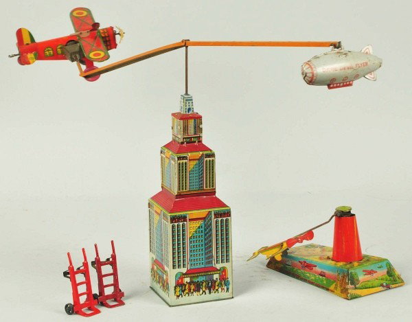 Lot of 2: Tin Litho Marx Airplane Wind-Up Toys.: Description American. Working. Includes one Lucky Stunt Flyer with airplane spinning around and up and down base. Nice tin lithography depicts the Statue of Liberty. Also includes one Dare Devil Flyer