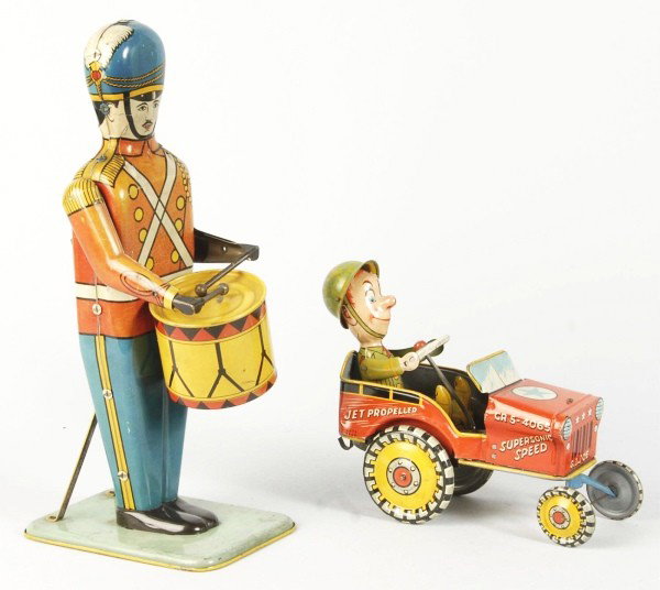 Lot of 2: Tin Litho Character Wind-Up Toys.: Description American. Working. Includes large size No. 27 Drum Major by Wolverine with some fading to red litho on front and Unique Art GI Joe Jeep toy. Both toys with some scratching and wear overall