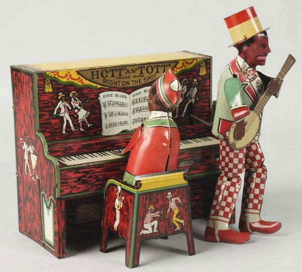 Tin Unique Art Hott & Tott Minstrel Band Toy.: Description American. Wind-up mechanism is working. Scarce variation of the Strauss Ham & Sam Band with Hott & Tott and Unique Art label over the original tin litho. Some minor scratching and wear to