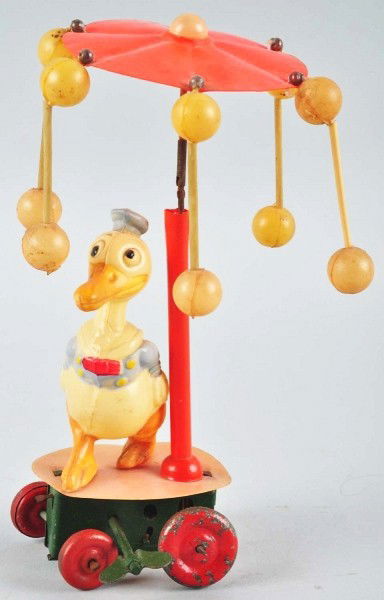 Celluloid Donald Duck Whirligig Wind-Up Toy.: Description Japanese. Working. Base is tin. Figure marked "Made in Occupied Japan" on rear. Some paint wear and loss to wheels and fading to celluloid balls. One stanchion (with two celluloid balls) i