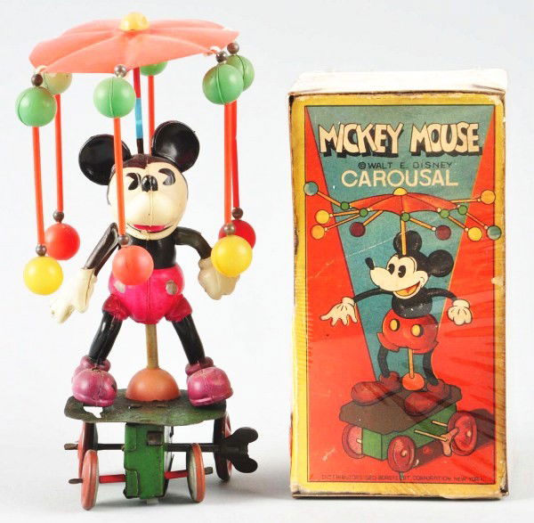 Celluloid Disney Mickey Carousel Wind-Up Toy.: Description Japanese. Circa 1930s. Working. Celluloid figure with metal base. Mickey has some denting to left foot and base has some wear and pitting throughout. Includes partial front of original box