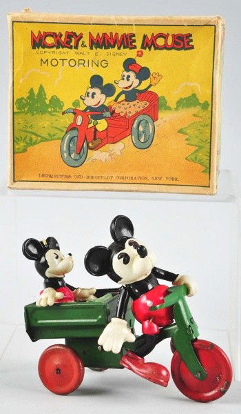 Celluloid Mickey & Minnie Mouse Motoring Toy.: Description Japanese. Circa 1930s. Working. Celluloid figures are riding on a tin wind-up cart. Marked "Made in Japan" on bottom of cart. Small dent to left side of Mickey's head that is slightly push