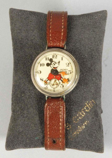 Ingersoll Disney Mickey Mouse Wrist Watch.: Description Pre-war. Scarce English version with running Mickey second dial and Mickey's hands as the hands of the clock. Leather band. Condition (Very Good). Size 1" Dia. Dimensions:1" Dia.