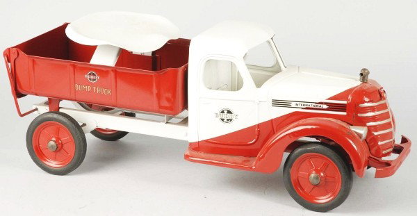 Pressed Steel Buddy L Hydraulic Dump Truck.: Description American. Circa 1938. International front cab with dual tone, slant paint and a dump body missing its hydraulic mechanism. Contains its ride on seat but missing its pull handle. Complete r