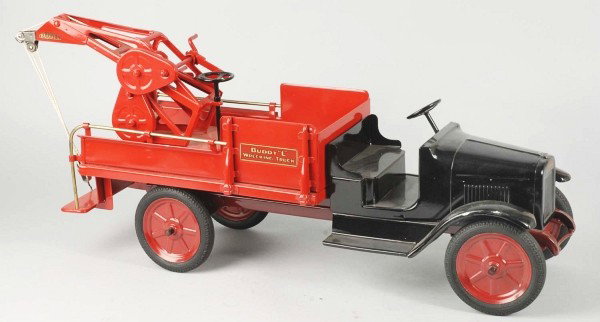 Pressed Steel Buddy L Wrecking Truck.: Description American. International open cab, rotating rear wrecking boom on a utility body with brass handrails and rubber tires. Professional restoration to an all original toy. Condition (Restored)