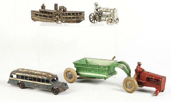 Lot of 4: Cast Iron Vehicle Toys.: Description American. Various makers include Hubley, Arcade, and others. Includes one Hubley tractor pulling a hay wagon with one missing tire, one small tractor with nickel wheels, one GMC Greyhound