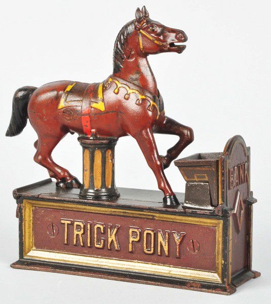 Cast Iron Trick Pony Mechanical Bank.: Description Manufactured by Shepard Hardware Co. Designed by Juleus Mueller, patented 6/2/1885. Red base. The pony receives the coin in his mouth and deposits it in the manger. A trap door at the bott