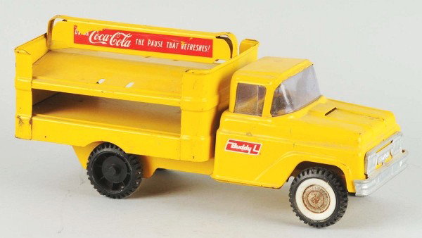 Buddy L Coca-Cola Truck Toy.: Description 1960s. Medium soiling, overall wear, chips, marks, and decal loss to both sides. Condition (Very Good). Size 14 - 1/2" L. Dimensions:14 - 1/2" L.
