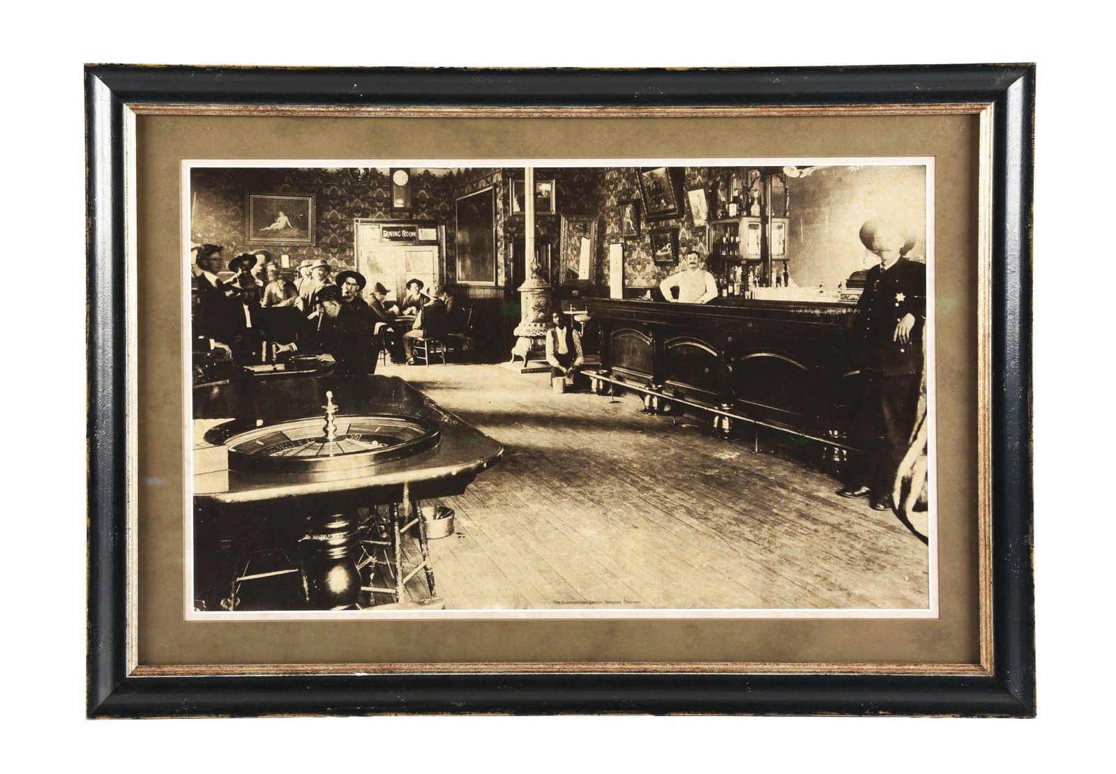 FRAMED AND MATTED CARDBOARD LITHOGRAPH OF THE COSMOPOLITAN SALOON, TELLURIDE, COLORADO. (1 of 3)