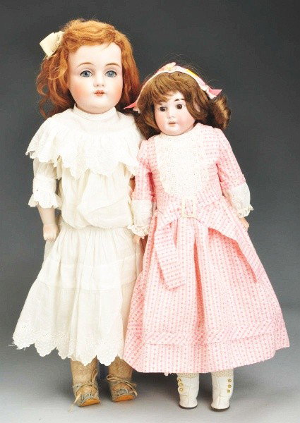Lot of 2: German Bisque Child Dolls.: Early pale bisque shoulder head COD93, stationary brown eyes, painted upper and lower eyelashes, multi-stroked eyebrows, replaced wig; kid body with new arms, redressed; beautiful Kestner 154 shoulder