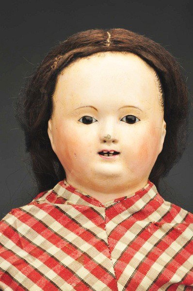 French Papier-Mache Shoulder Head Doll.: Open mouth, four carved Bamboo teeth, inset glass eyes without pupils, painted hair with defined comb marks around face edge and ears, on an antique Muslin stuffed body with joints at shoulders, hips 