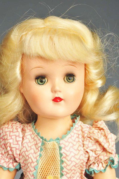 Ideal Hard Plastic "Toni" Doll.: All hard plastic P-90W doll with blue lashed sleeping eyes, eye shadow, original platinum blonde wig; walking body, separated fingers; totally factory original in tagged "Genuine Toni Doll" pique dres