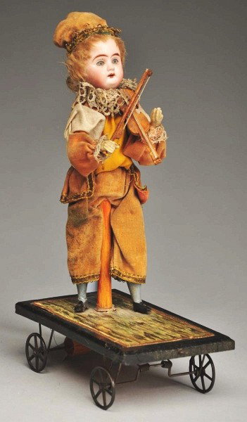 German Mechanical Pull Toy.: Bisque head with glass eyes and open mouth; as the toy is pulled, the boy moves his head and his arm to play the violin; original clothing (somewhat soiled); nifty little toy. Size: 9" T.