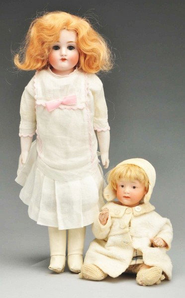 Lot of 2: German Bisque Dolls.: Kestner 154 bisque shoulder head, blue sleeping eyes with real upper eyelashes, multi-stroked eyebrows, open mouth with teeth, plaster pate, original blonde mohair wig, kid body (soil, replaced kid lo