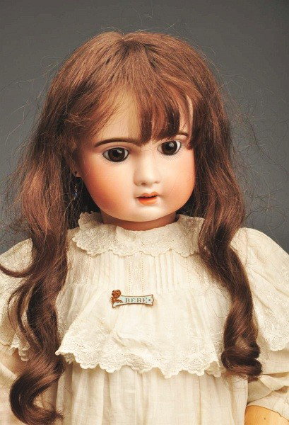 French Bisque Bêbê Doll.: Unmarked bisque socket head by Jumeau (professional repair at side of forehead, does not affect features), brown paperweight eyes with threaded iris, painted upper and lower eyelashes, long multi-stro