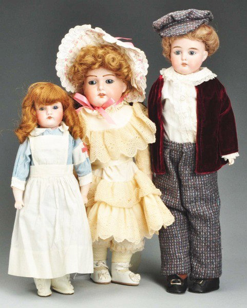 Lot of 3: German Bisque Child Dolls.: Kestner 154, stationary eyes, open mouth with upper square teeth, replaced wig (glued down tightly), kid body with bisque lower arms, vintage nurse's uniform, replaced shoes; bisque shoulder head A.M.
