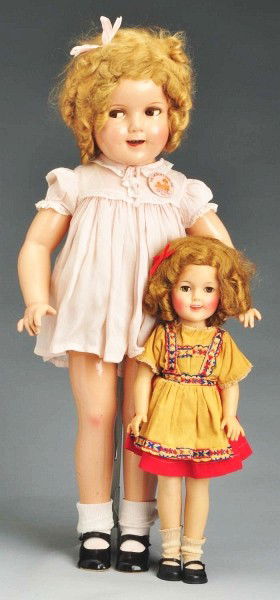 Lot of 2: Child Star "Shirley Temple" Dolls.: Ideal Vinyl 1950s Shirley fully marked ST 17, all original in Heidi style dress, underwear, shoes and socks. Large composition Shirley (cracking on arms and legs, overall crazing on face) with lashed