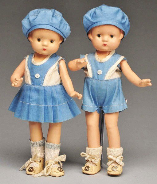 Lot of 2: Effanbee "Patsyette" Twins.: Brother and sister are composition and marked. Molded hair with painted eyes, all factory original costumes of blue and white cotton with hat, shoes, and socks. Size: Each: 9" T.