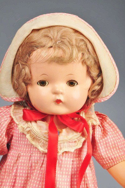 Sweet Effanbee "Patsy Joan".: All composition and marked (light crazing). Original short curly mohair wig, clear brown lashed sleeping eyes, factory original red and white cotton dress (light fading, wear to ruffle), matching undi