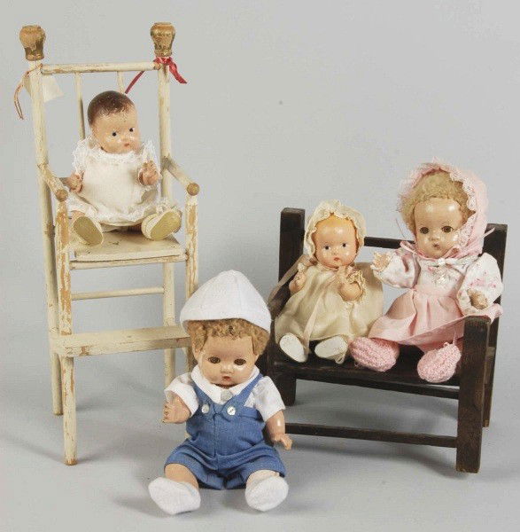 Lot of 4: Effanbee Composition Baby Dolls.: Pair of "Patsy Babyette" babies with caracul wigs (wear, crazing) in replaced clothing. Pair of "Patsy Baby Tinyette" Babies, one redressed (crazing and wear), another with factory original dress, mat