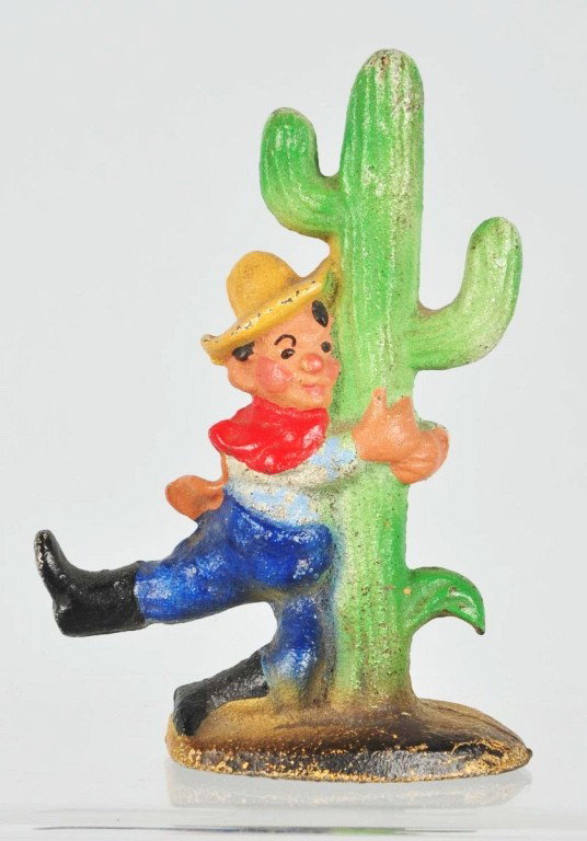 Cast Iron Cowboy by Cactus Bottle Opener.: Manufactured by John Wright. Size: 3 - 3/4" T. Condition: (Excellent).