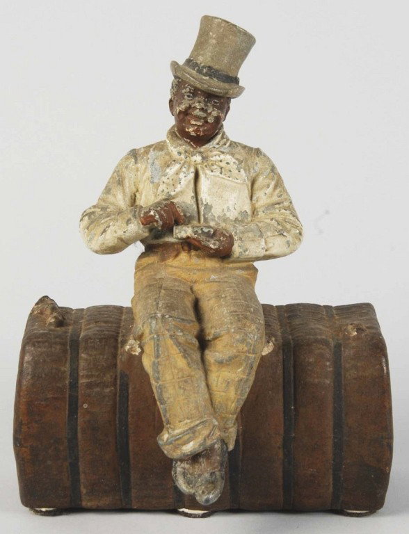Cast Iron Man on Bale of Cotton Doorstop.: Manufactured by cjo (Judd Co.). Figure is pot metal and cotton bale is cast iron. Size: 9" T. Condition: (Very Good).