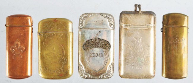 Lot of 5: Assorted Match Safes.: Includes one Anheuser-Busch match safe one with an acorn and address of 104 Grand St. on it, one brass match safe with an etched four leaf clover, one with a shield, and one brass match with fleur-de-