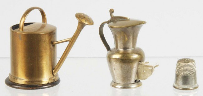 Lot of 2: Metal Figural Tape Measures.: Includes one wind-up watering can and one wind-up pitcher mug with thimble inside and no tab. Size: Largest: 2" T. Condition: (Excellent).