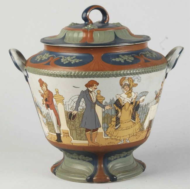Mettlach Villeroy & Boch Punch Bowl with Lid.: Signed "Heinrich Schlitt". Depicts an outdoor scene with man playing violin, man approaching a lady, man serving drinks out of a punch bowl on table, man playing a flute, and a couple dancing. No dama