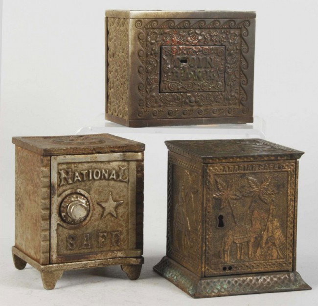Lot of 3: Cast Iron Safe Still Banks.: Includes the Arabian, the National, and the coin bank. Size: Largest: 4 - 3/4" T. Condition: (Very Good - Excellent).